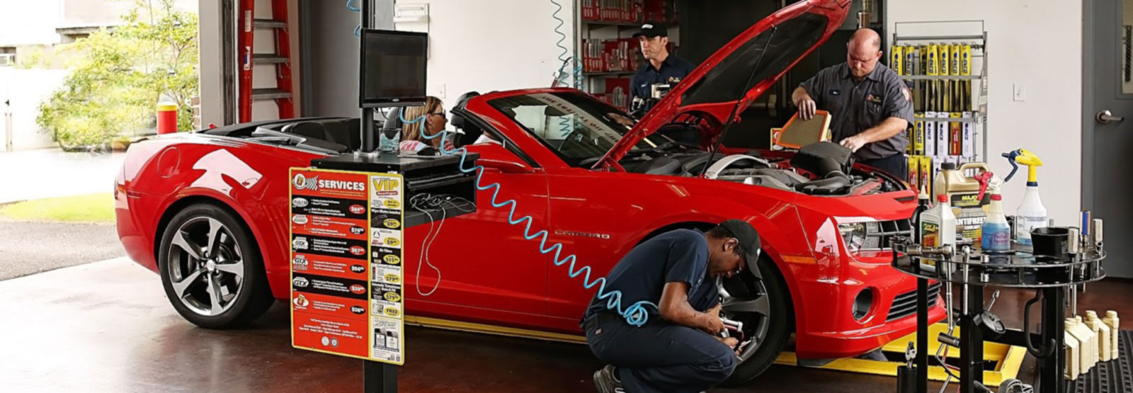 Techs servicing a sports car